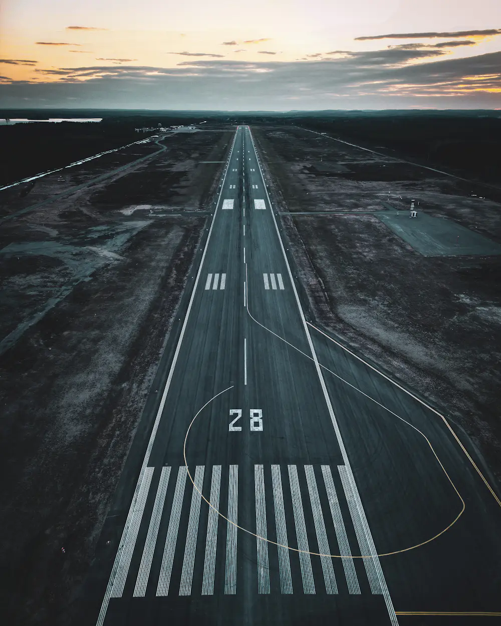 Airport runway photographed from the air at sunset