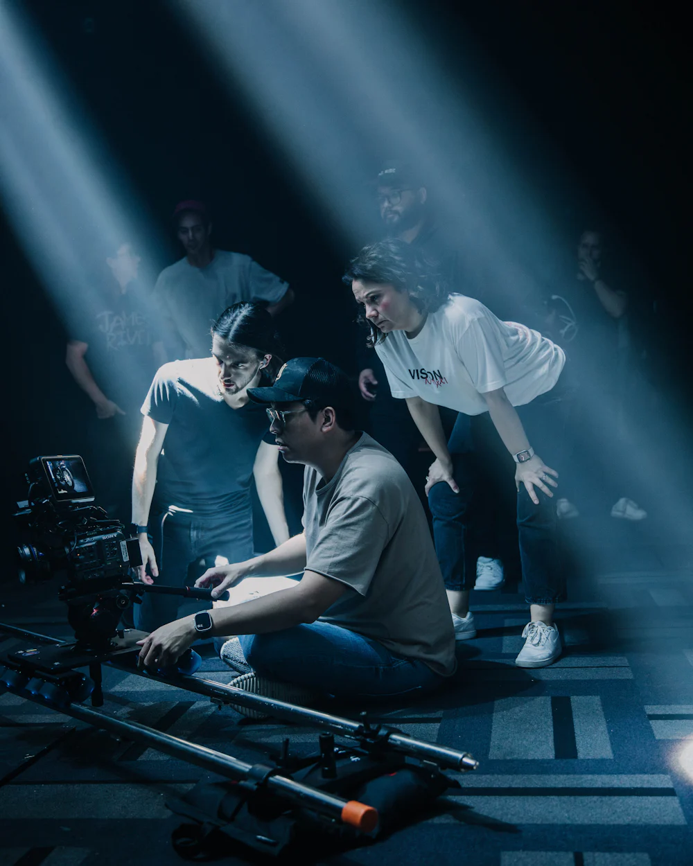 Crew working around a camera on set