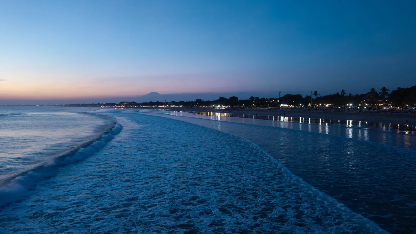 Aerial view of Kuta Beach in Bali, a core location for tourism drone filming