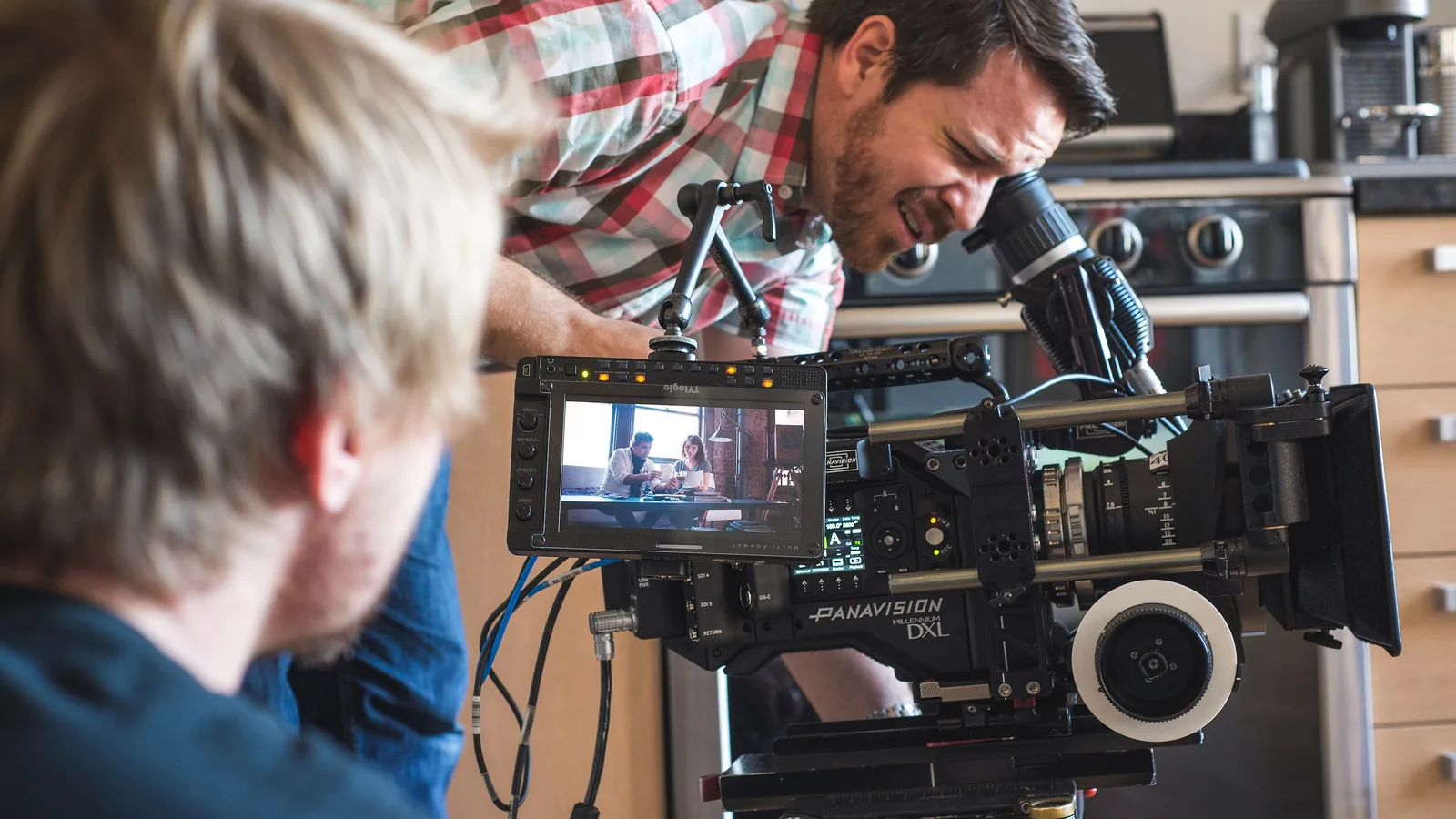 Cinematographer operating a professional camera on location, as foreign film crews do in Bali