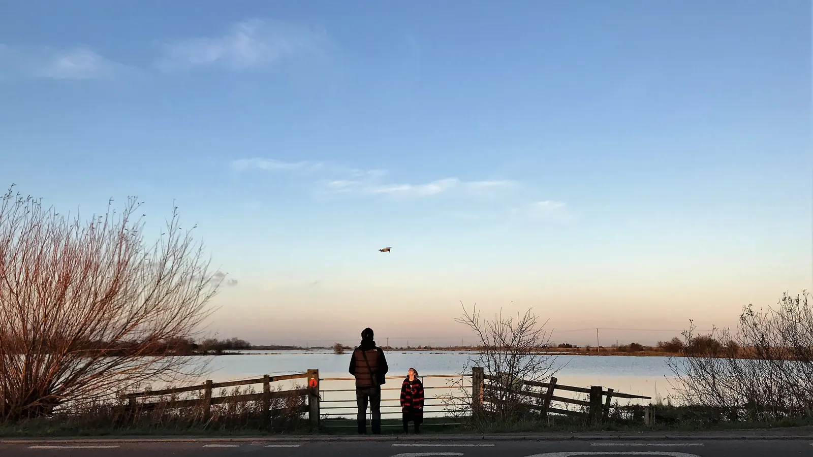 Drone operator surveying terrain from the ground, the kind of mapping KKOP planning needs