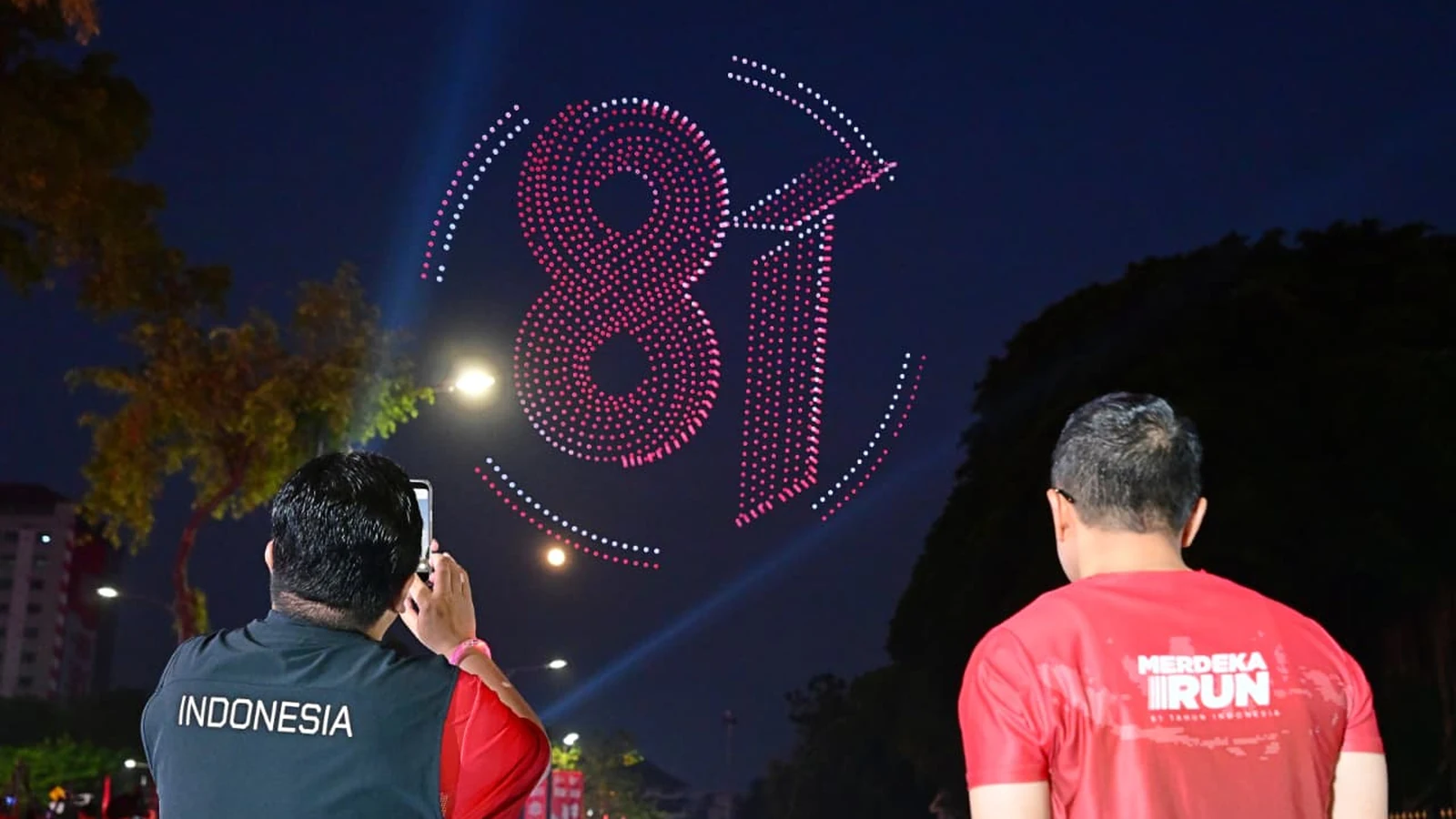 Drone display flying above a large public event in Indonesia, requiring event permits