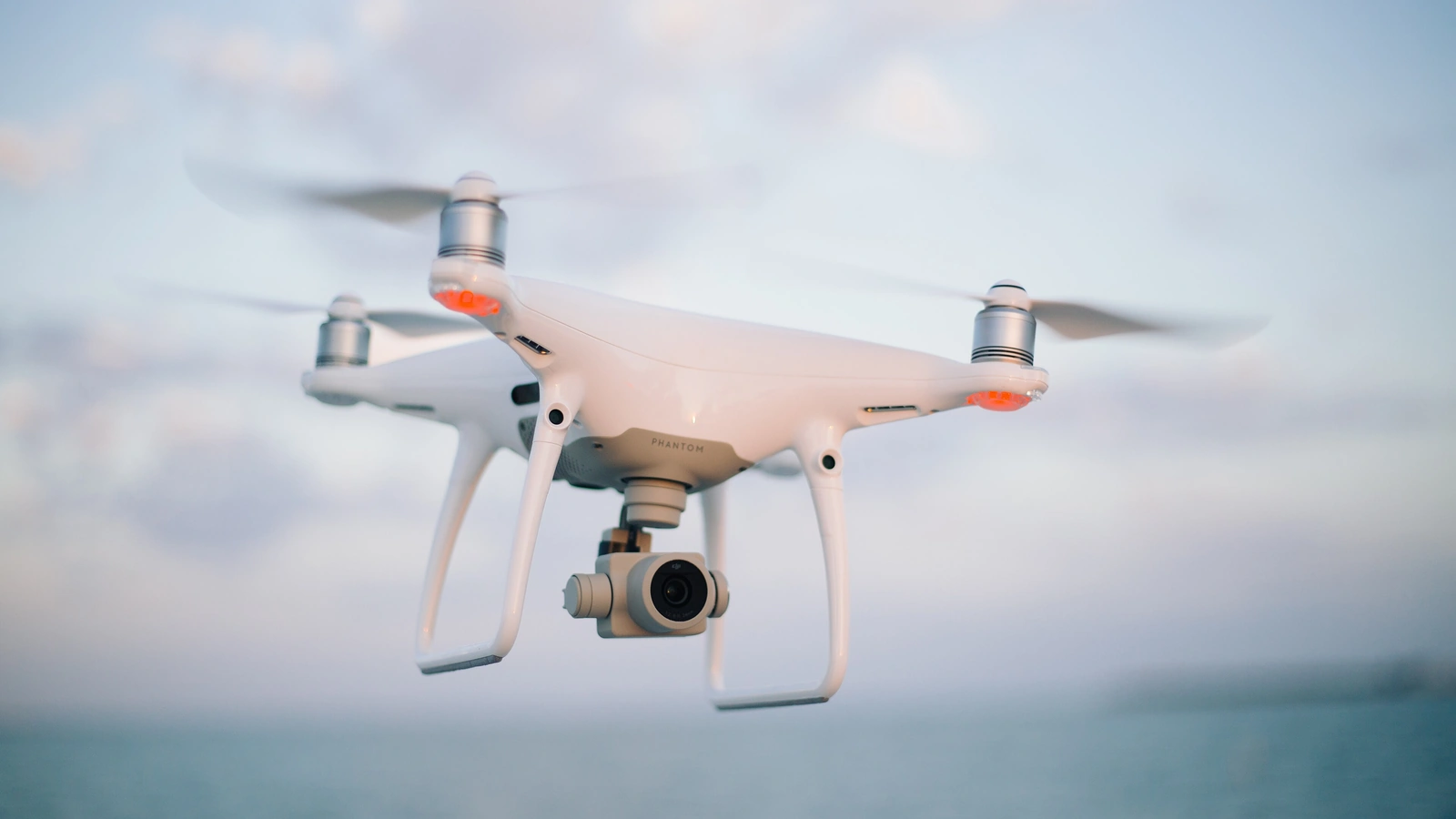 Camera drone hovering in clear sky, illustrating insurance cover for Bali drone permits